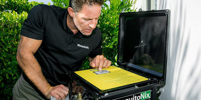 Technician checking Mosquitonix equipment
