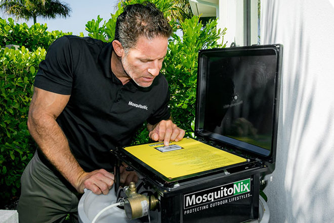 Technician checking Mosquitonix equipment